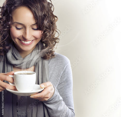 Photo: Beautiful Woman with cup of Tea or Coffee Beautiful Woman with cup of Tea or Coffee