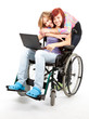 invalid girl on the wheelchair with laptop and friend