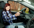 young beautiful woman driving her new car