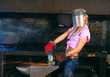 Attractive girl in workshop with instrument in hand Attractive girl in workshop with instrument in hand