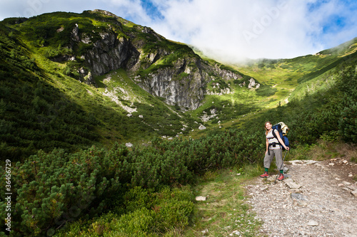 Photo: Backpacker girl exploring the mountains. Backpacker girl exploring the mountains.