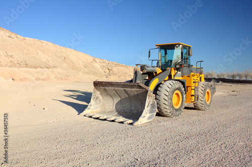 Photo: Front view of loader machine at the construction zone Front view of loader machine at the construction zone
