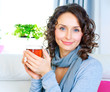 Beautiful Young Woman drinking hot tea