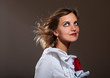 Daydreamed woman in white blouse with red flower