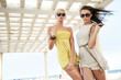 Two adorable women walking in a sunny day