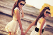 Two smiling woman on the beach