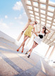 Two adorable women walking in a sunny day