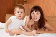 mother with baby on white sheet mother with baby on white sheet