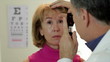 Optometrist using an ophthalmoscope Optometrist using an ophthalmoscope