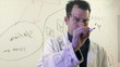 Scientist Writing on a Clear Board