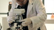 Lab Tech Looking Through Microscope