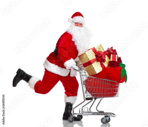 Photo: Santa Claus with gifts and shopping trolley. Santa Claus with gifts and shopping trolley.