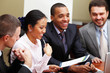 Multi ethnic business team at a meeting. Interacting.
