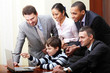Kid boy explains multi ethnic business team how to work