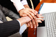 Image of business people hands on top of each other.