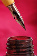 Ink pen and ink on the red background