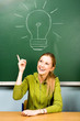Female student and light bulb on chalkboard