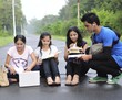 Group of Indian college students studying at the middle of road.