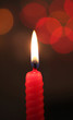red candle on dark background