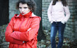 Photo: Two young pensive women standing in park. Two young pensive women standing in park.