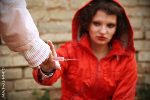 Photo: a young woman to a syringe take a drug a young woman to a syringe take a drug