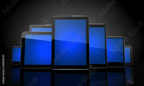 Photo: Digital pads with blue touchscreens on black Digital pads with blue touchscreens on black
