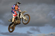 The spectacular jump moto racer on a motorcycle