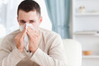 Foto: Young man blowing his nose Young man blowing his nose