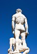 Behind statue of Hercules on blue sky