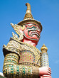 The Red Giant Statue , Blue Sky on Background The Red Giant Statue , Blue Sky on Background