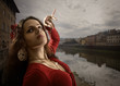 woman in  red dress dances on the bank of the Arno.