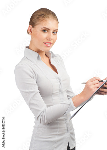 Photo: Business woman writing on clipboard Business woman writing on clipboard