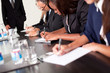 Group of business executives taking notes