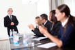 Business people sitting in a row at meeting