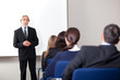 Mature businessman giving business training