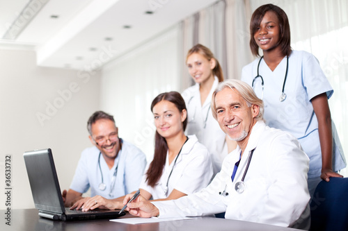 Photo: Attractive female doctor working on her laptop Attractive female doctor working on her laptop