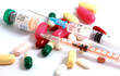 Pills of many shapes and colors grouped together