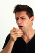 Sick man coughing into he's hand