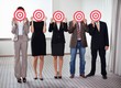 Group of business people holding a target