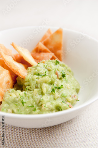 Photo: Bowl with guacamole and nachos Bowl with guacamole and nachos