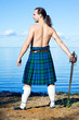 Man with naked torso in kilt