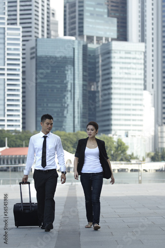 Photo: Businessman and Businesswoman Walking Businessman and Businesswoman Walking
