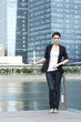 Business woman standing in front of office building