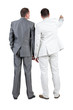 Back view of two businessman pointing at wall. rear view.