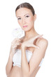 Young beautiful brunette woman holding flower in her hands over