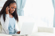 Woman on the phone while using laptop