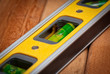 Yellow spirit level over wooden boards