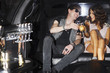 Couple toasting each other in backseat of limo