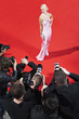 Celebrity posing for paparazzi on red carpet