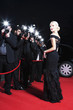 Celebrity posing for paparazzi on red carpet